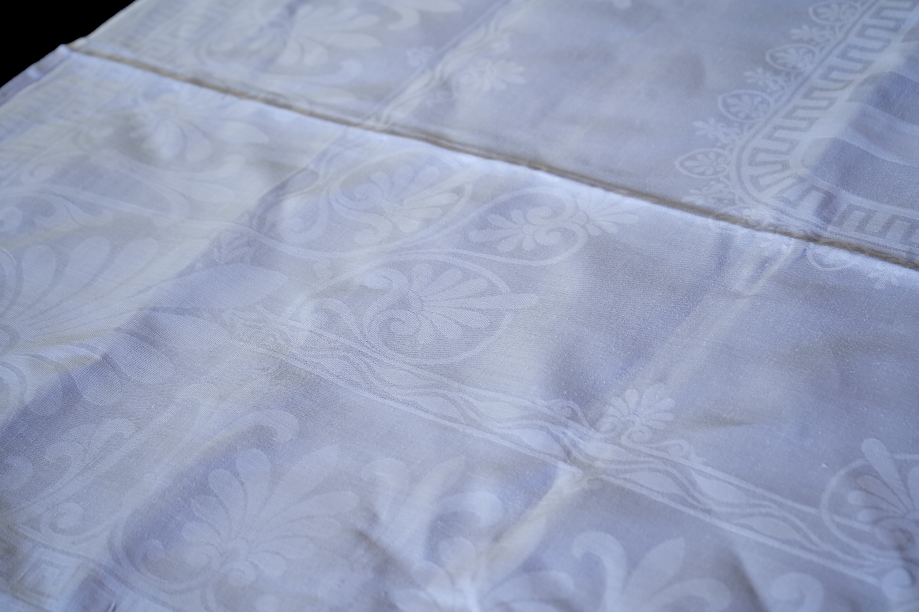 A late 19th century large white Irish damask table cloth, woven with an all over Christopher Dresser ‘inspired’ design. The overall design incorporating many of his known stylistic design motifs. Each corner has a shamro